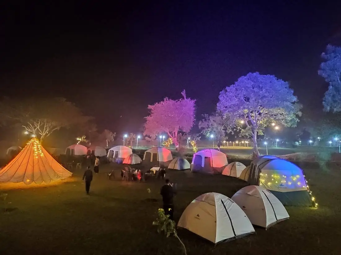 Camping tents lit up at night at Hiranya Resorts