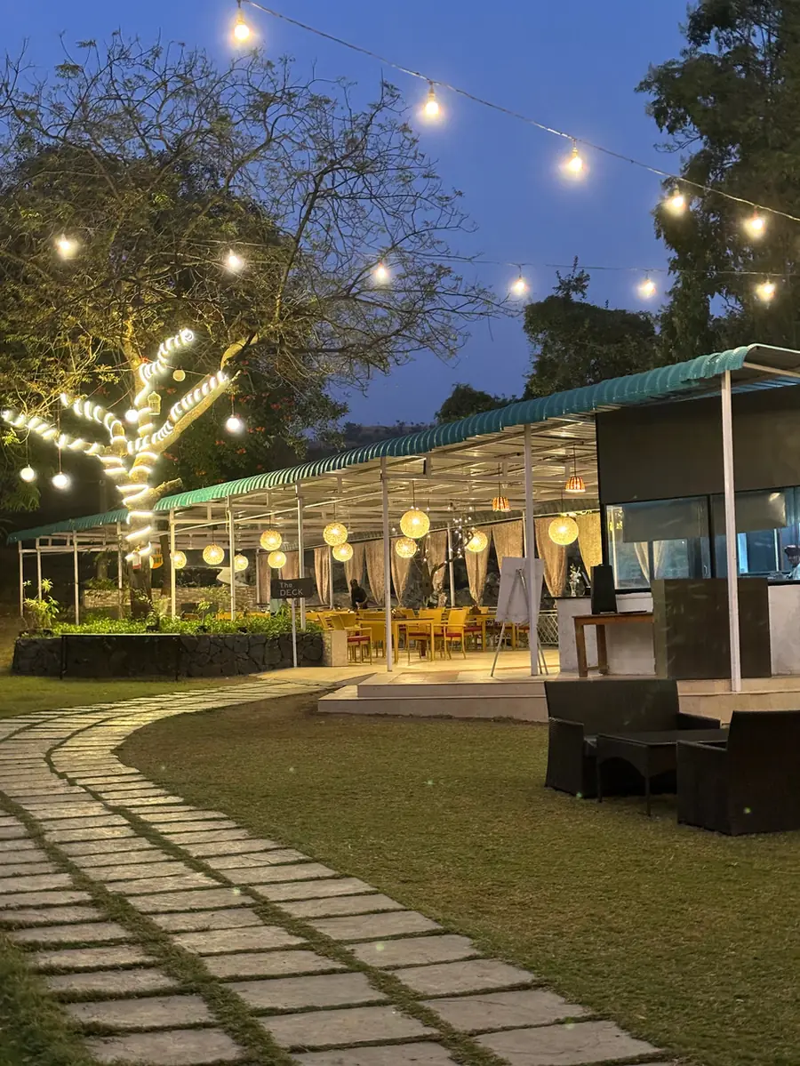 Cottages at Hiranya Resorts glowing with fairy lights at dusk