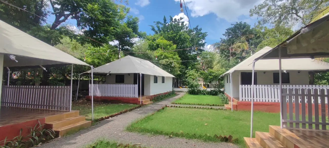 Swiss-style glamping cottages on the lawn at Hiranya Resorts