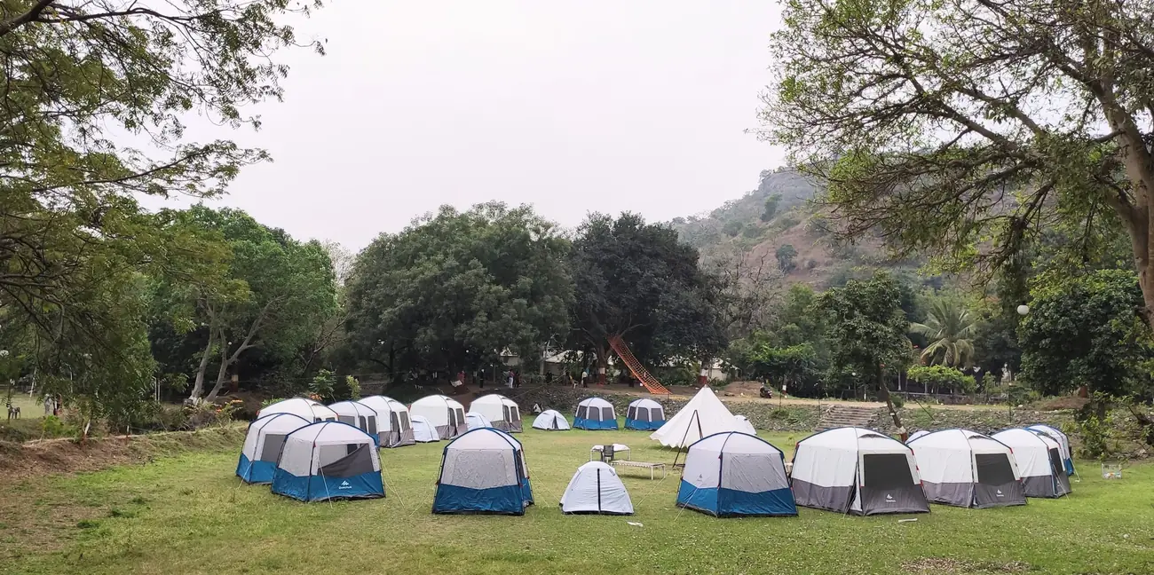 Circle of camping tents on the lawn at Hiranya Resorts